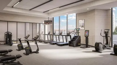 a gym with treadmills and cardio equipment in a building at Apiary Hotel Belleview Station in Denver