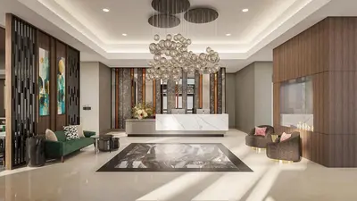 a lobby with a chandelier and chairs and a table at Apiary Hotel Belleview Station in Denver