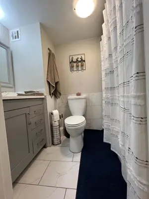 a bathroom with a white toilet and a sink at Stylish Stay In Downtown Denver in Denver