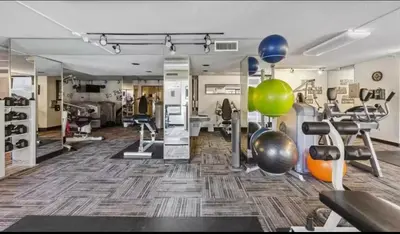 a room with a gym with exercise equipment and balloons at Stylish Stay In Downtown Denver in Denver