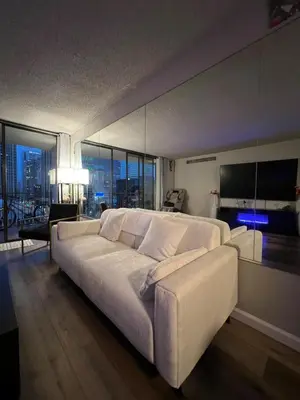 a living room with a large white couch and a large window at Stylish Stay In Downtown Denver in Denver