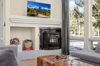 a living room with a fireplace and a tv at Stillwood Retreat in Bailey