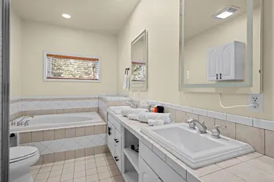 a bathroom with a sink and a tub and a toilet at Stillwood Retreat in Bailey