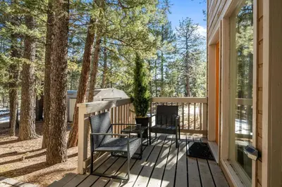 a deck with two chairs and an umbrella at Stillwood Retreat in Bailey