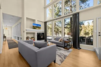a living room with a couch and chairs and windows at Stillwood Retreat in Bailey