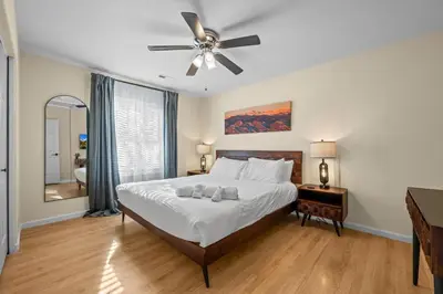 a bedroom with a bed and a ceiling fan at Stillwood Retreat in Bailey