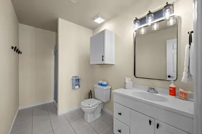 a bathroom with a toilet and a sink and a mirror at Stillwood Retreat in Bailey
