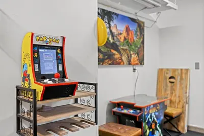 a room with a video game machine and a table at Stillwood Retreat in Bailey