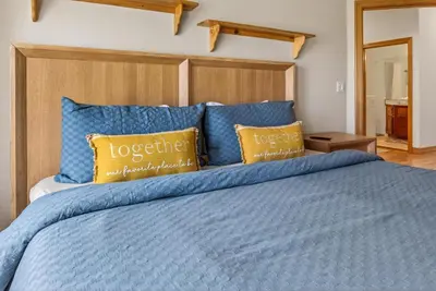 a bedroom with a blue bed with yellow pillows at Scenic Mountain Home, Media Room, TT, Gym in Boulder