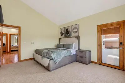 a bedroom with a bed and a mirror at Scenic Mountain Home, Media Room, TT, Gym in Boulder