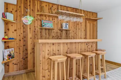 a bar with wooden walls and stools in a room at Scenic Mountain Home, Media Room, TT, Gym in Boulder