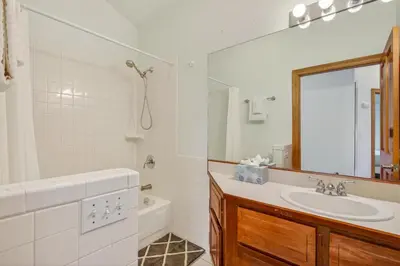 a white bathroom with a sink and a mirror at Scenic Mountain Home, Media Room, TT, Gym in Boulder