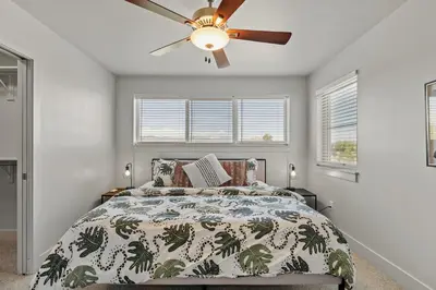a bedroom with a bed with a ceiling fan at Modern Retreat - Close to Old Town in Fort Collins