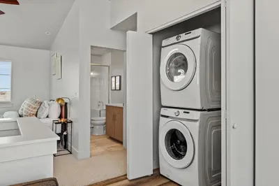 a laundry room with a washer and dryer in it at Modern Retreat - Close to Old Town in Fort Collins