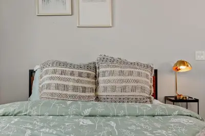 a bed with two pillows on top of it at Modern Retreat - Close to Old Town in Fort Collins
