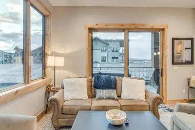 a living room with a couch and a table at Walk to Ski Shuttle and Brewery! New Fraser Condo in Fraser
