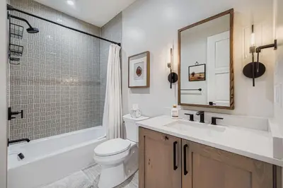 a bathroom with a toilet and a sink and a mirror at 37 Alcove townhouse in Keystone