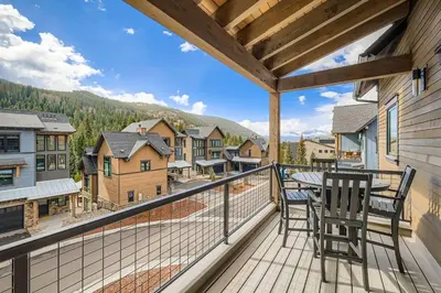 a balcony with a table and chairs and a view at 37 Alcove townhouse in Keystone
