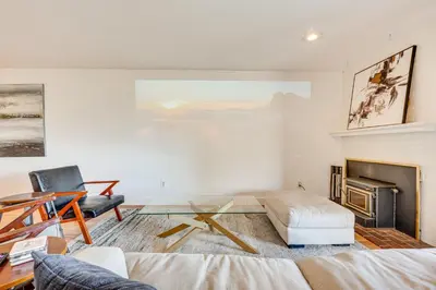a living room with a couch and a table at 1 Mi to CU Boulder! Walkable Condo with Indoor Pool in Boulder