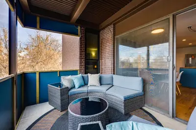 a patio with a couch and a table on a balcony at 1 Mi to CU Boulder! Walkable Condo with Indoor Pool in Boulder