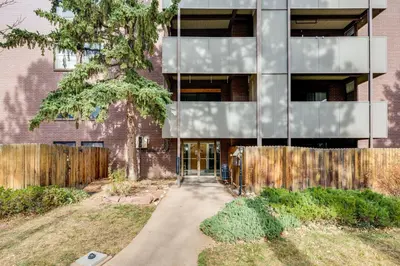 an external view of a brick building with a door at 1 Mi to CU Boulder! Walkable Condo with Indoor Pool in Boulder