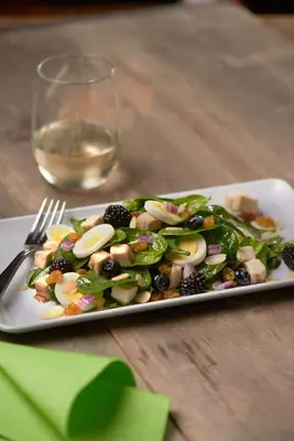 a plate of salad on a table with a glass of wine at Hyatt Place Denver Tech Center in Centennial