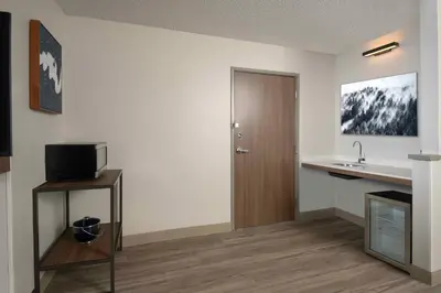 a room with a sink and a bathroom with a door at Hyatt Place Denver Tech Center in Centennial