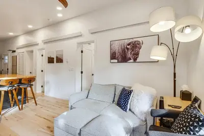 a living room with a couch and a table at New Luxury Modern Riverside Scandinavian Cabin in Breckenridge
