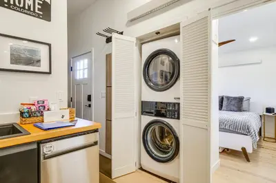 a kitchen with a washer and dryer in a room at New Luxury Modern Riverside Scandinavian Cabin in Breckenridge