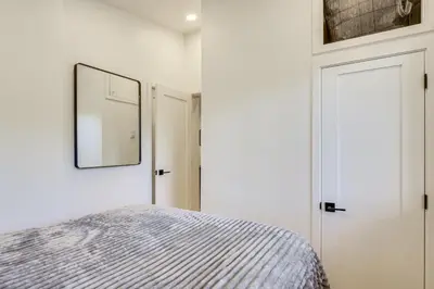 a bedroom with a bed and a mirror on the wall at New Luxury Modern Riverside Scandinavian Cabin in Breckenridge