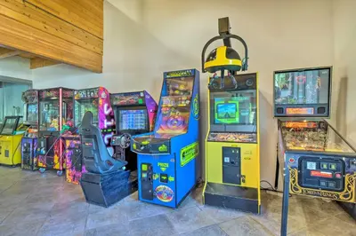 a group of video games in a room with arcade machines at New Luxury Modern Riverside Scandinavian Cabin in Breckenridge