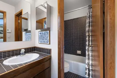 a bathroom with a sink and a toilet and a mirror at Keystone Gulch - Near Keystone Resort & Golf in Keystone