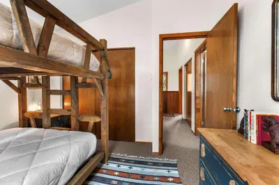 a bedroom with two bunk beds and a hallway at Keystone Gulch - Near Keystone Resort & Golf in Keystone