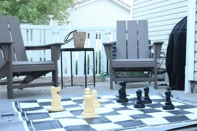 a chess board and two chairs on a patio at Modern Luxe Stay • Bright & Photo-Ready in Westminster