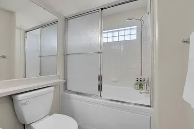 a bathroom with a toilet and a glass shower at Modern Luxe Stay • Bright & Photo-Ready in Westminster