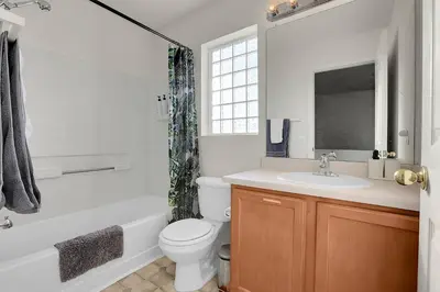a bathroom with a toilet and a sink and a bath tub at Modern Luxe Stay • Bright & Photo-Ready in Westminster