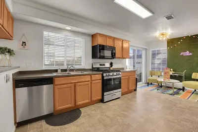 a kitchen with a sink and a stove top oven at Modern Luxe Stay • Bright & Photo-Ready in Westminster