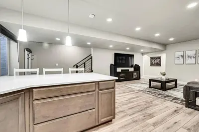 a kitchen with a counter and a living room at Modern 5BR/3BA Luxury Home|Movie Nights & Comfort in Evans