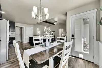a dining room and kitchen with a table and chairs at Modern 5BR/3BA Luxury Home|Movie Nights & Comfort in Evans
