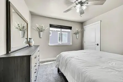 a bedroom with a bed and a ceiling fan at Modern 5BR/3BA Luxury Home|Movie Nights & Comfort in Evans