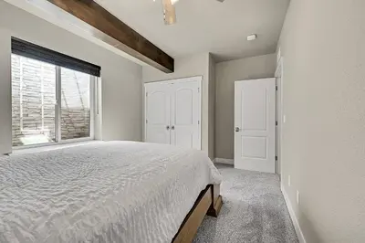 a bedroom with a bed and a window at Modern 5BR/3BA Luxury Home|Movie Nights & Comfort in Evans