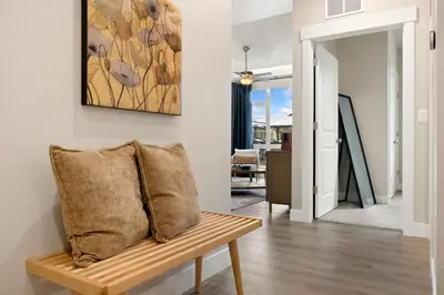 a living room with a bench and a painting at The Landmark with Two King Beds, Garage and Fireplace in Fort Collins