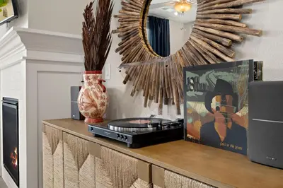 a room with a mirror and a record player on a counter at The Landmark with Two King Beds, Garage and Fireplace in Fort Collins