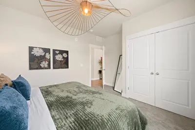 a bedroom with a bed and a chandelier at The Landmark with Two King Beds, Garage and Fireplace in Fort Collins
