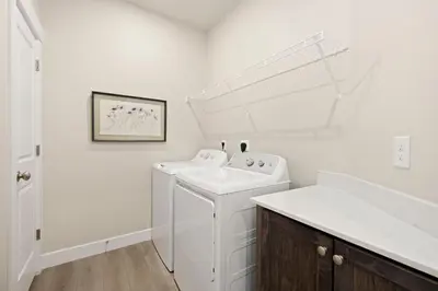 a white washer and dryer in a bathroom at The Landmark with Two King Beds, Garage and Fireplace in Fort Collins