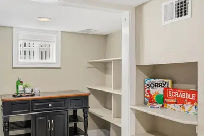 a walk in pantry with a black desk and shelves at Kanons Kottage Downtown Retreat Near RMNP in Loveland