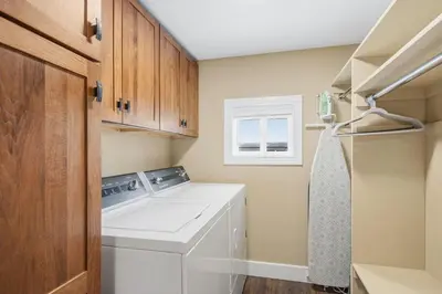 a small laundry room with a washer and dryer at Kanons Kottage Downtown Retreat Near RMNP in Loveland