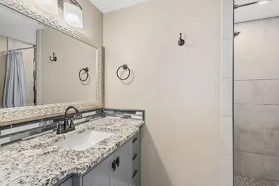a bathroom with a sink and a shower at Kanons Kottage Downtown Retreat Near RMNP in Loveland