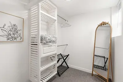 a white closet with a mirror in a room at Mathews House with 4 King Beds Near CSU and Old Town in Fort Collins