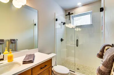 a bathroom with a shower and a toilet and a sink at Saltwater Hot Tub! Unit Near Winter Park Slopes in Fraser